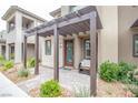 Inviting front entrance featuring a charming pergola, stone accents, and a cozy seating area at 541 Tokopah Falls St, Las Vegas, NV 89138