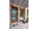 Welcoming front porch with cozy seating, a modern glass door, and stylish brick pavers at 541 Tokopah Falls St, Las Vegas, NV 89138