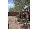 Low maintenance backyard featuring desert landscaping and a brick wall at 6092 Fox Creek Ave, Las Vegas, NV 89122