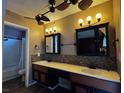 Bathroom with dual sinks, a tiled backsplash and a shower-tub combo at 6421 Doby Peak Dr, Las Vegas, NV 89108