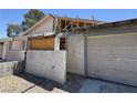 Garage with unfinished walls, garage door, exposed framing, and general disrepair at 6723 Oak Valley Dr, Las Vegas, NV 89103