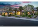 Charming home featuring a three-car garage, desert landscaping, and beautiful trees at 7738 Willow Cove Cir, Las Vegas, NV 89129