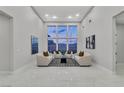 Bright living room with high ceilings, modern furnishings, and large windows at 7738 Willow Cove Cir, Las Vegas, NV 89129