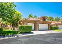Attractive home featuring a tile roof, two-car garage and manicured landscaping for curb appeal at 8236 Round Hills Cir, Las Vegas, NV 89113