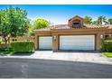 Inviting home with a tile roof, two-car garage, and well-maintained landscaping in front of the property at 8236 Round Hills Cir, Las Vegas, NV 89113