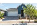 Attractive single-story home boasts a two-car garage, brick-paved driveway, and desert landscaping at 832 Canonbury St, Henderson, NV 89011