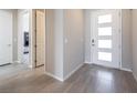 Welcoming foyer showcasing modern tile flooring and a contemporary front door with sidelights at 832 Canonbury St, Henderson, NV 89011