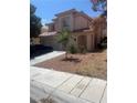 Charming two-story home features a well-manicured front yard and a spacious three-car garage at 9365 Sparkling Waters Ave, Las Vegas, NV 89129