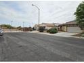Neighborhood street view showcasing the home's proximity to the community gate at 9462 Alhambra Valley St, Las Vegas, NV 89178