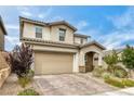 Beautiful home featuring a well-manicured lawn, brick driveway, and attractive architectural details at 9876 Heather Moore Ave, Las Vegas, NV 89166