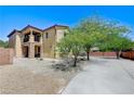 Exterior angle view of a two-story home showing second story deck and desert landscaping at , North Las Vegas, NV 89084
