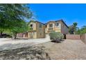 Two-story home featuring a two-car garage and desert landscaping under a blue sky at , North Las Vegas, NV 89084