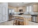 Open kitchen boasts an island with seating, stainless appliances, and ample cabinet space at 1017 Pebble Lake St, Henderson, NV 89011