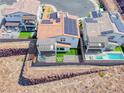 Aerial shot of a modern home with solar panels, a jacuzzi, and manicured green space at 1038 Delbrook Ave, Henderson, NV 89012
