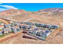 An aerial view of homes featuring solar panels, desert landscaping, and mountain views at 1038 Delbrook Ave, Henderson, NV 89012
