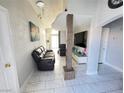 Spacious living room with a column accent, marble flooring, and comfortable seating at 1505 Lilac Breeze Cir, Las Vegas, NV 89108