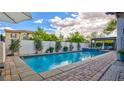 Refreshing pool with brick trim, water feature and patio area, perfect for outdoor relaxation at 1869 Bronze Patina St, Henderson, NV 89044