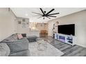 Comfortable living room with plank floors, a large fan, and an eat-in kitchen in an open concept design at 2451 N Rainbow Blvd # 2076, Las Vegas, NV 89108