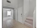 Inviting entryway with tiled floor leads to carpeted stairs and living space at 2586 Begonia Valley Ave, Henderson, NV 89074