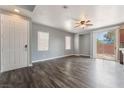 Open-concept living room featuring a ceiling fan, hardwood floors, and natural light at 28 Yellow Flame Ave, North Las Vegas, NV 89084