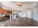 Spacious open living area with vinyl floors, view of staircase, and access to kitchen at 28 Yellow Flame Ave, North Las Vegas, NV 89084
