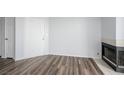Open living room with wood flooring, fireplace, and white door at 3550 Bay Sands Dr # 3006, Laughlin, NV 89029