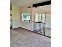 Open living area with neutral carpet and a railing, perfect for entertaining at 3729 La Junta Dr, Las Vegas, NV 89120