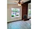 Bright living room featuring a brick fireplace and large window with neighborhood views at 3729 La Junta Dr, Las Vegas, NV 89120