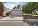 Charming single-story home with a well-manicured lawn and a two-car garage at 3936 Applecrest St, Las Vegas, NV 89108