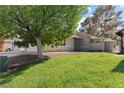 Well-maintained front yard with lush green grass and mature shade trees at 3936 Applecrest St, Las Vegas, NV 89108
