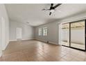 Open-concept living room with tile and wood flooring, natural light, and access to the backyard at 3936 Applecrest St, Las Vegas, NV 89108