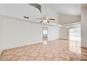 Bright living room features vaulted ceilings, ceiling fans and neutral paint with tile floor at 420 Clifton Heights Dr, Las Vegas, NV 89145