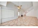 Inviting living area featuring a fireplace, vaulted ceilings, and large windows for natural light at 420 Clifton Heights Dr, Las Vegas, NV 89145