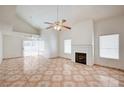 Open concept living room with ceiling fan and decorative fireplace for cozy nights at 420 Clifton Heights Dr, Las Vegas, NV 89145
