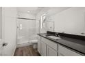 Bathroom featuring a glass shower and modern vanity with dark countertop at 4940 Canna Lily St, Las Vegas, NV 89122