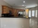 Open kitchen with stainless steel appliances, granite countertops, and ample cabinet space for storage at 5524 Markley Ave, Las Vegas, NV 89141