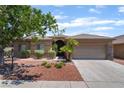 Beautifully landscaped home with a well-maintained lawn, mature trees, and a cozy front porch at 5586 Golden Leaf Ave, Las Vegas, NV 89122
