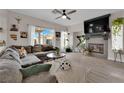 Cozy living room with a fireplace, large TV, gray sofa and lots of natural light at 6108 Shallow Springs St, Las Vegas, NV 89130