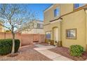 Home's front entrance with a brick wall and a small metal gate providing private access at 6320 Desert Leaf St # 101, North Las Vegas, NV 89081