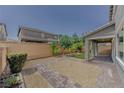 Landscaped backyard with gravel, brick pavers, artificial turf, and covered patio at 6403 Ava Ridge Ave, Las Vegas, NV 89141