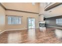 Spacious living room with vaulted ceilings, fireplace, and sliding glass doors to the backyard at 7267 W Mesa Vista Ave, Las Vegas, NV 89113