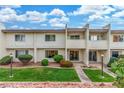 Desirable two-story condo showcases manicured lawn, vibrant greenery, and a cozy, private balcony at 768 Lawrence Dr, Henderson, NV 89015