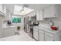 Bright kitchen with marble countertops, stainless steel appliances, and a garden view window at 768 Lawrence Dr, Henderson, NV 89015