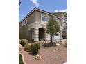 Two-story home featuring a two-car garage, landscaped front yard and a charming facade with arched windows at 8116 Russell Creek Ct, Las Vegas, NV 89139