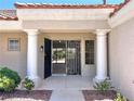 Inviting front entrance with decorative security door, tile roof, and stately columns at 8513 Festival Dr, Las Vegas, NV 89134