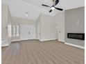 Bright living room with sleek fireplace, vaulted ceiling, and wood-look floors at 8513 Festival Dr, Las Vegas, NV 89134
