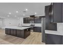 Beautiful, modern kitchen with dark cabinetry, stainless steel appliances, and a large island at 9570 Thistle Creek Ave, Las Vegas, NV 89178