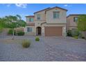 Traditional two-story home showcasing a well-maintained front yard and a brick driveway at 9654 Starfish Reef Way, Las Vegas, NV 89178