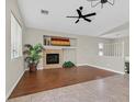 Spacious living room with wood floors, fireplace, and large windows at 11022 Saint Rafael St, Las Vegas, NV 89141