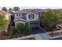 An elevated view of a two-story home with a well-maintained front yard and a two-car garage at 11731 Longworth Rd, Las Vegas, NV 89135